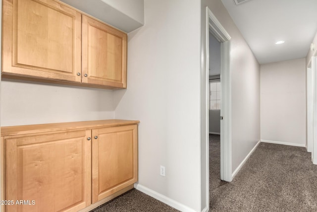 corridor with dark colored carpet