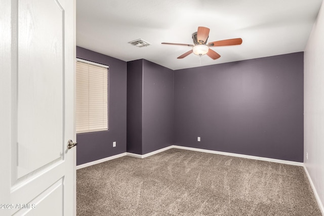 carpeted spare room with ceiling fan