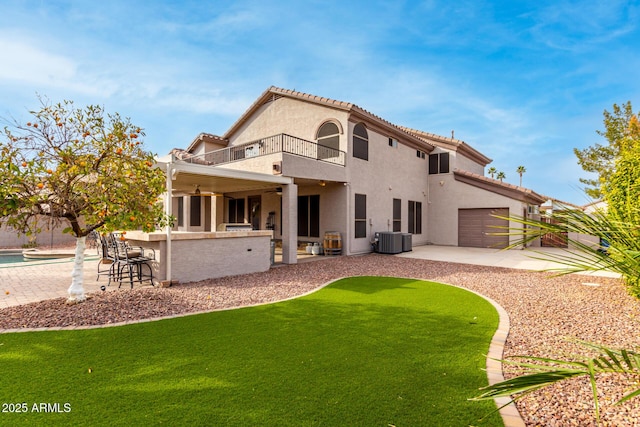 rear view of property with a balcony, central AC unit, ceiling fan, exterior bar, and a patio