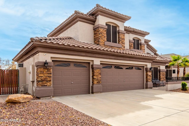 mediterranean / spanish-style home with a garage