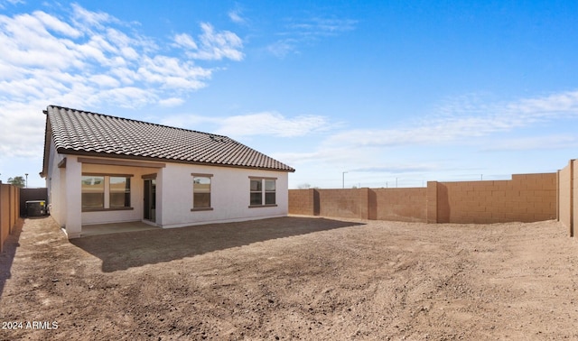 rear view of property featuring central AC