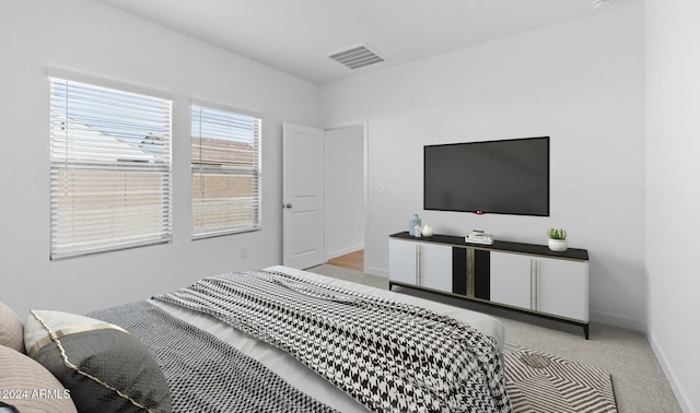 bedroom featuring light colored carpet