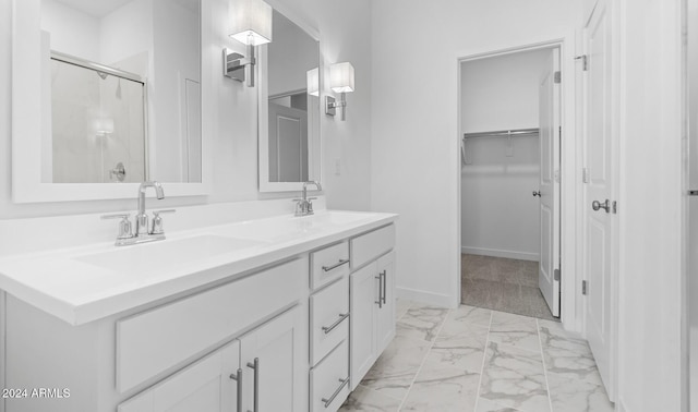 bathroom with vanity and a shower with door