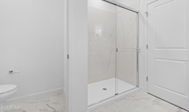 bathroom featuring an enclosed shower and toilet