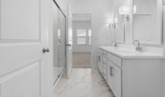 bathroom featuring vanity and a shower with shower door