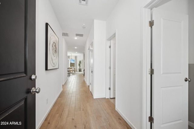 corridor with light hardwood / wood-style flooring