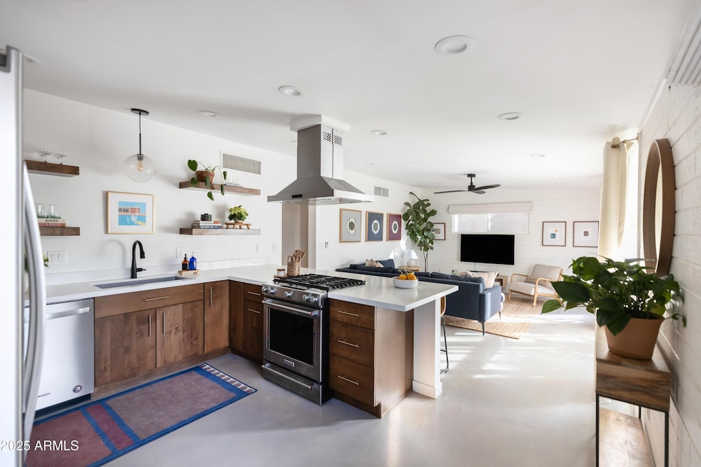 kitchen with sink, decorative light fixtures, kitchen peninsula, island exhaust hood, and stainless steel appliances