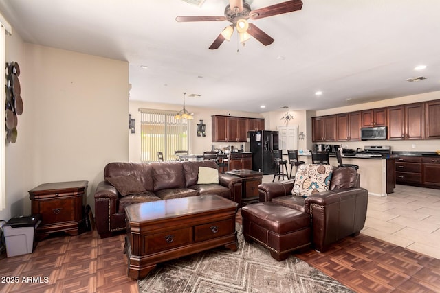 living area with ceiling fan and recessed lighting
