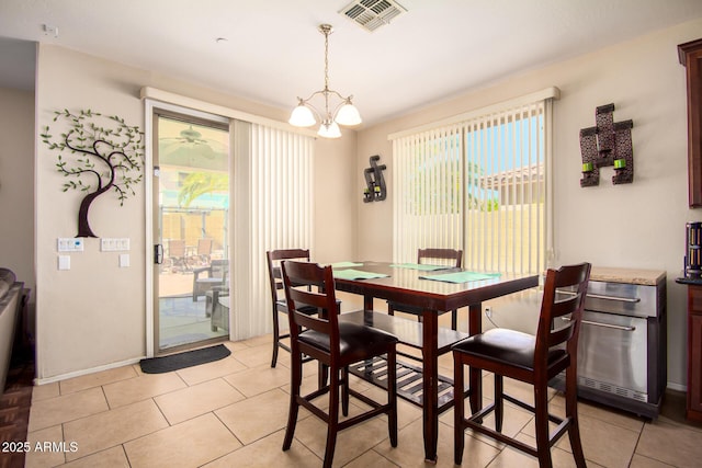 dining room featuring baseboards, visible vents, an inviting chandelier, and light tile patterned flooring