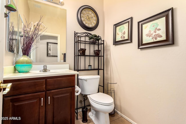 bathroom with toilet, visible vents, baseboards, tile patterned flooring, and vanity