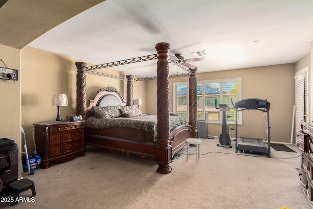 carpeted bedroom featuring visible vents and ceiling fan