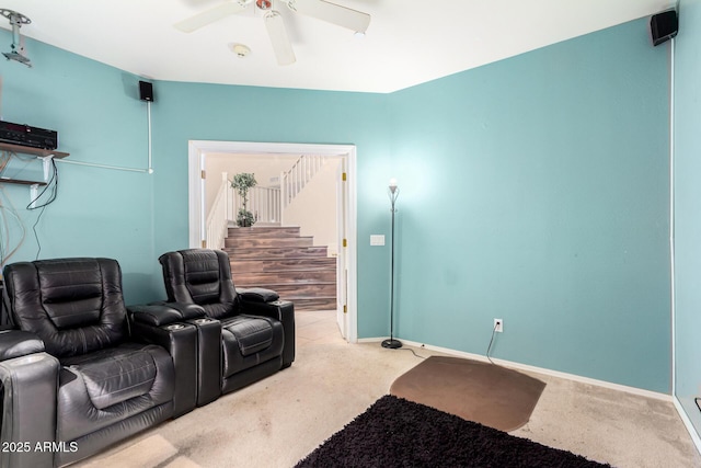 home theater featuring carpet, a ceiling fan, and baseboards