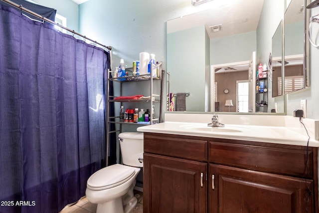 bathroom featuring tile patterned floors, visible vents, vanity, and toilet