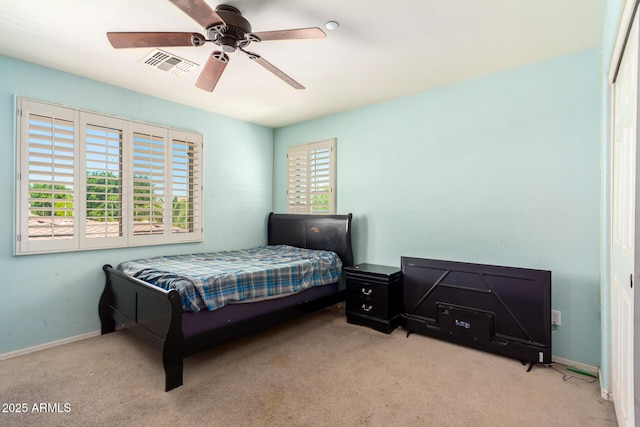 carpeted bedroom featuring visible vents, a ceiling fan, and baseboards