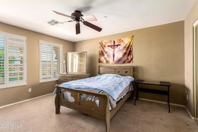 carpeted bedroom featuring visible vents, a ceiling fan, and baseboards