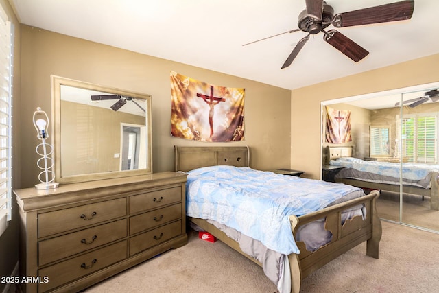 bedroom featuring a ceiling fan and light carpet