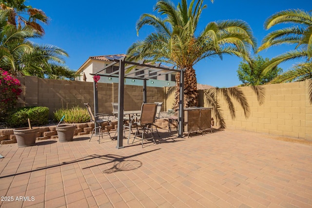 view of patio with outdoor dining space and a fenced backyard