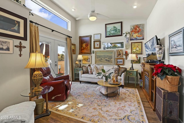 sitting room with baseboards, a ceiling fan, wood finished floors, and french doors