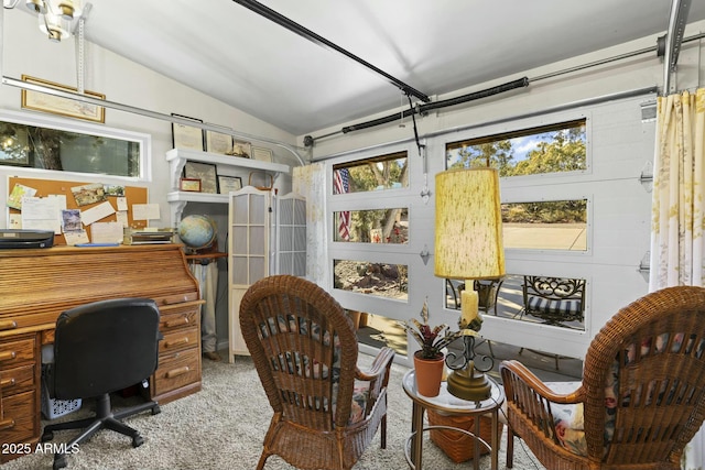 home office featuring lofted ceiling, carpet floors, and a wealth of natural light