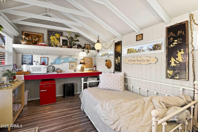 bedroom with lofted ceiling with beams and wood finished floors