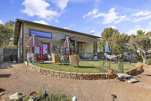 back of property with a patio, a lawn, and fence