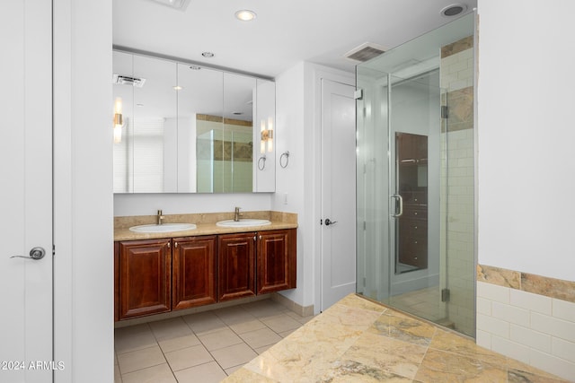 bathroom with walk in shower, tile patterned floors, and vanity