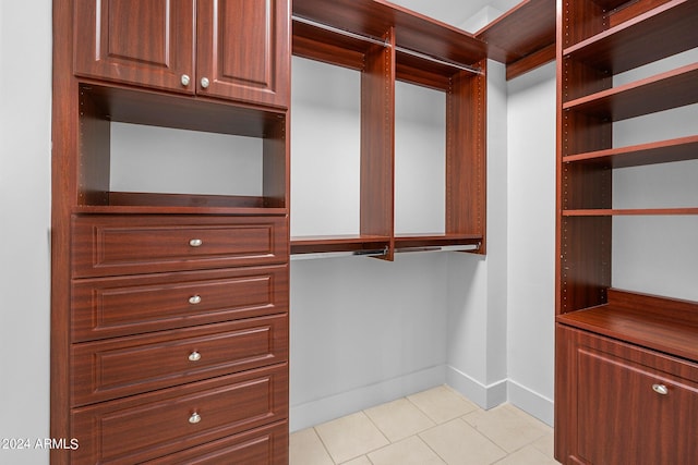 walk in closet with light tile patterned floors