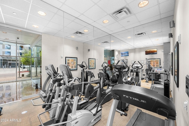 exercise room with a paneled ceiling