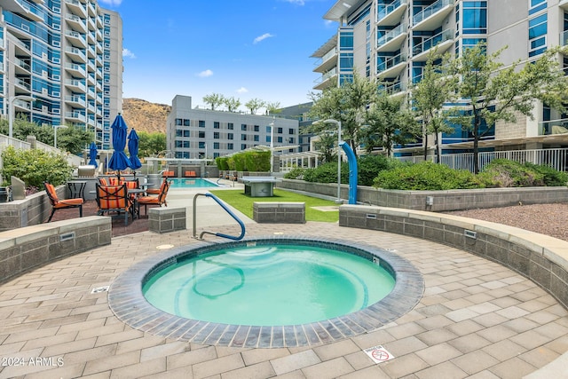 view of pool featuring a patio area and a community hot tub