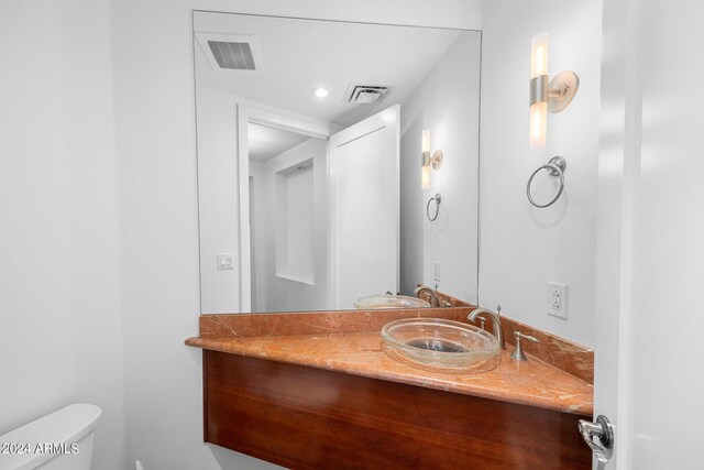 hall with dark tile patterned floors and sink