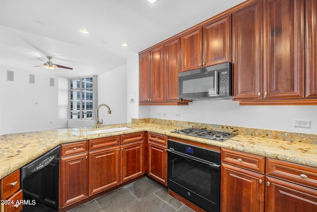 kitchen with sink, light stone counters, kitchen peninsula, ceiling fan, and black appliances