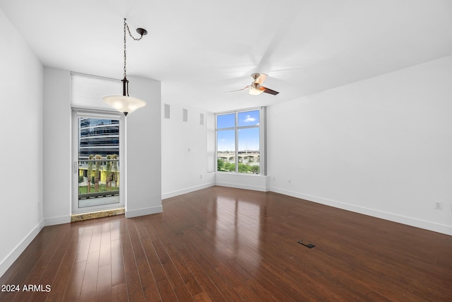 empty room featuring dark hardwood / wood-style floors and ceiling fan