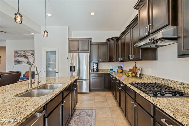 kitchen featuring stainless steel fridge with ice dispenser, dark brown cabinetry, under cabinet range hood, a sink, and black cooktop