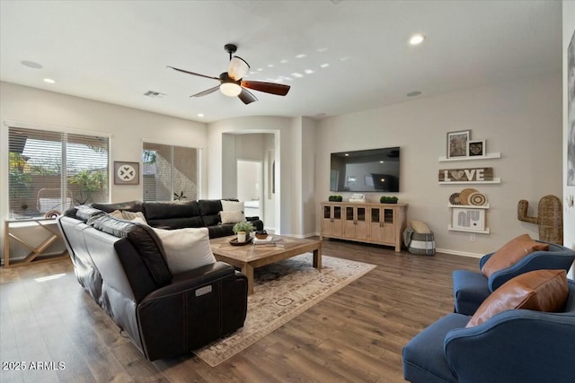 living area featuring wood finished floors, a ceiling fan, visible vents, and recessed lighting