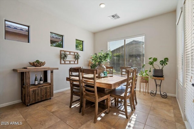 dining room with visible vents, baseboards, and light tile patterned flooring