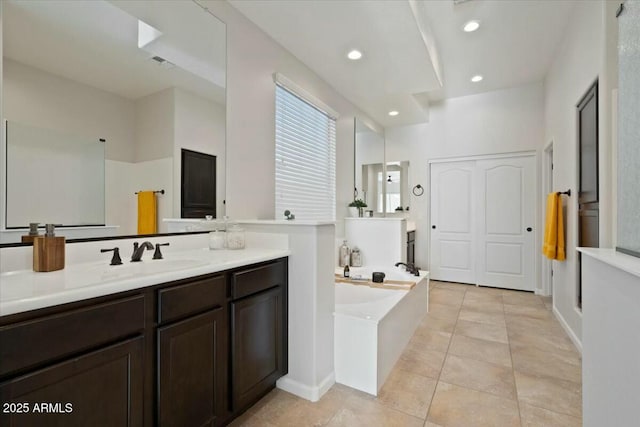 bathroom with a bath, tile patterned flooring, visible vents, recessed lighting, and a sink