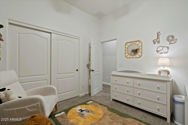 bedroom featuring visible vents, a closet, and carpet floors