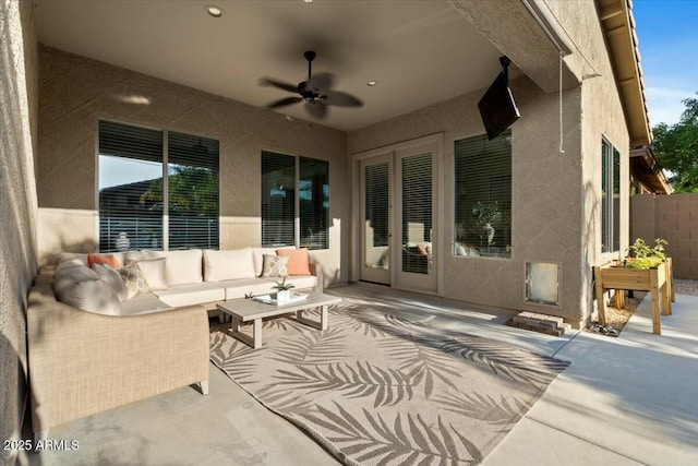 view of patio featuring fence, outdoor lounge area, and a ceiling fan