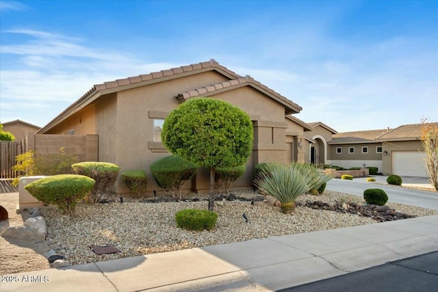 view of front of property featuring stucco siding and fence