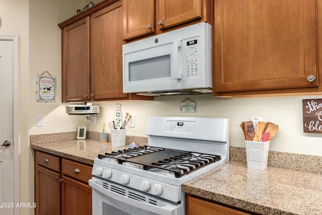 5735 S Cloverdale Ln, Gilbert, AZ 85298 - kitchen featuring white appliances and brown cabinets