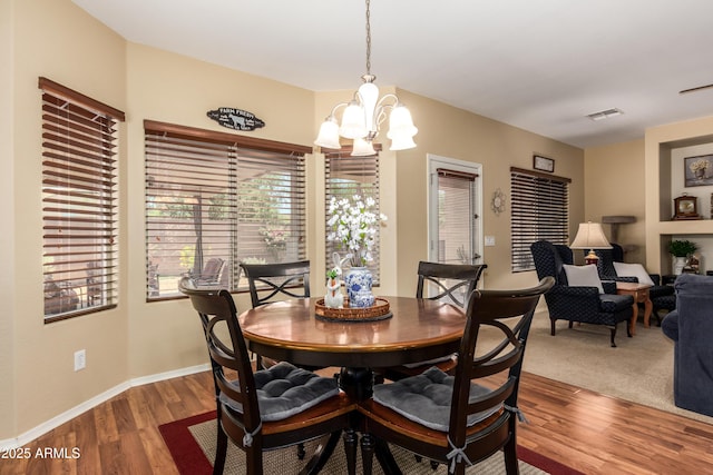 5735 S Cloverdale Ln, Gilbert, AZ 85298 - dining area featuring a chandelier and wood finished floors
