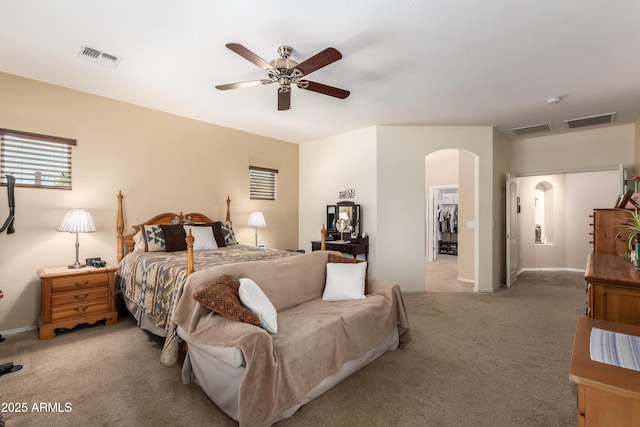 5735 S Cloverdale Ln, Gilbert, AZ 85298 - bedroom with arched walkways, light carpet, and a ceiling fan