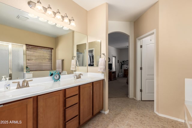 5735 S Cloverdale Ln, Gilbert, AZ 85298 - bathroom with a stall shower, double vanity, tile patterned floors, and a closet