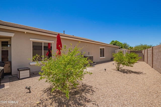 5735 S Cloverdale Ln, Gilbert, AZ 85298 - back of property with a storage shed, a fenced backyard, and stucco siding