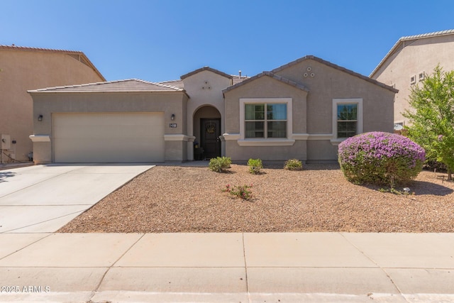 4108 N 304th Ln, Buckeye, AZ 85396 - mediterranean / spanish-style home with concrete driveway, a garage, stucco siding, and a tiled roof