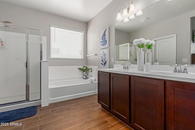 4108 N 304th Ln, Buckeye, AZ 85396 - full bathroom with a stall shower, double vanity, a garden tub, and wood finished floors