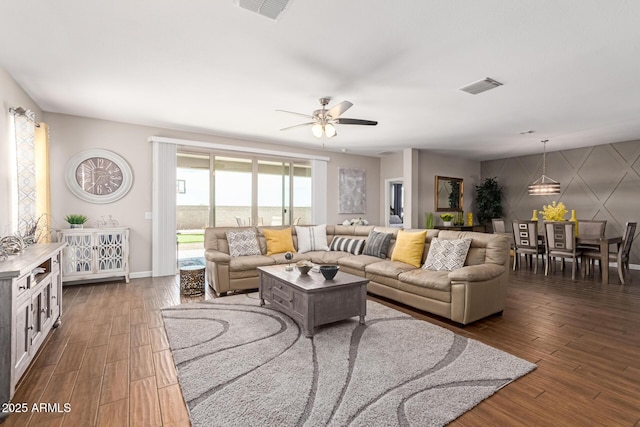 4108 N 304th Ln, Buckeye, AZ 85396 - living room featuring dark wood-type flooring and a ceiling fan