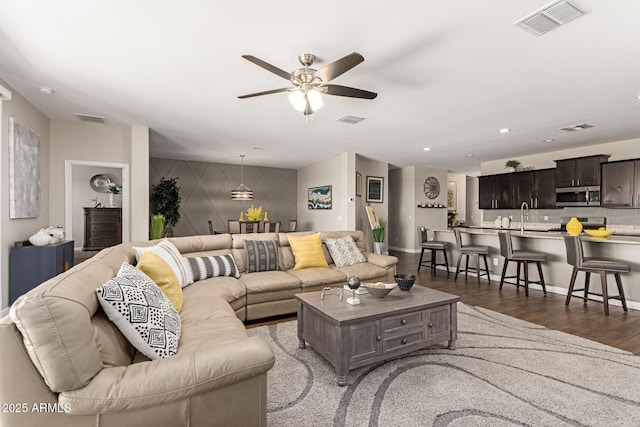 4108 N 304th Ln, Buckeye, AZ 85396 - living area featuring ceiling fan, an accent wall, wood finished floors, and recessed lighting