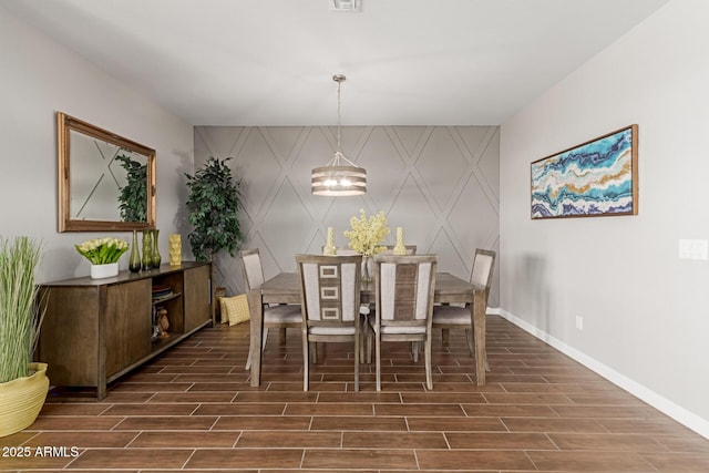 4108 N 304th Ln, Buckeye, AZ 85396 - dining space featuring wood tiled floors, a decorative wall, and an accent wall