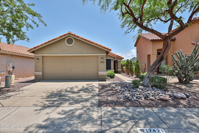 17421 N 14th St, Phoenix, AZ 85022 - view of front of house featuring concrete driveway, stucco siding, a garage, and a tile roof